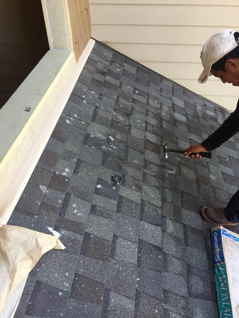 GEJ Roofing crew member nailing new CertainTeed shingles into place
