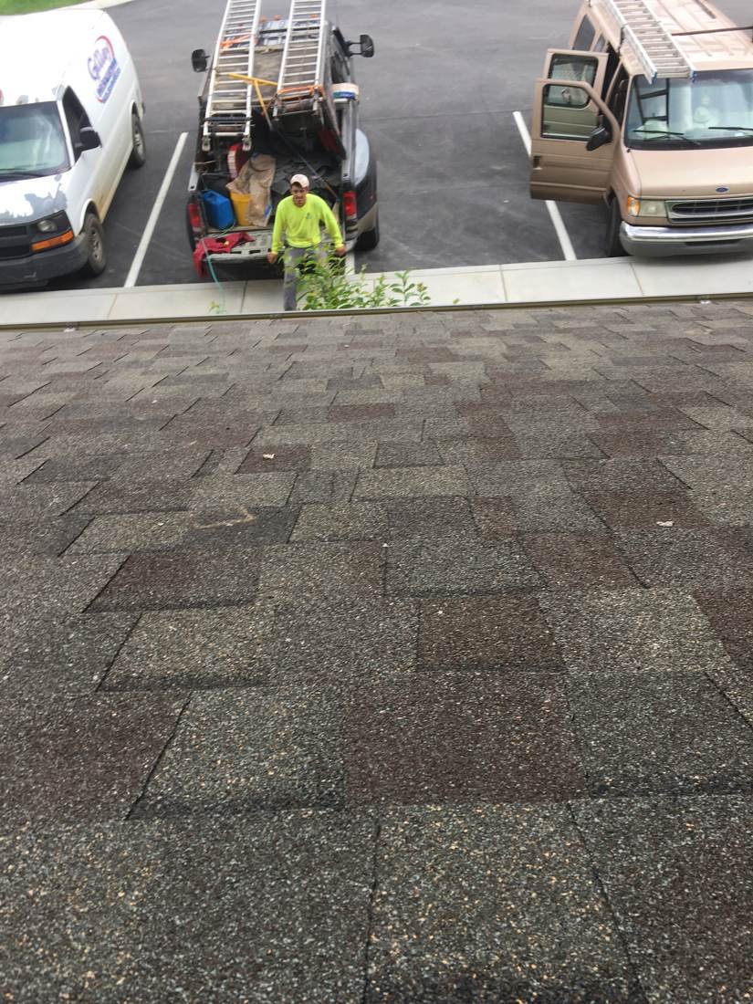 GEJ Roofing crew member carrying materials at the Gallatin, TN apartment job site