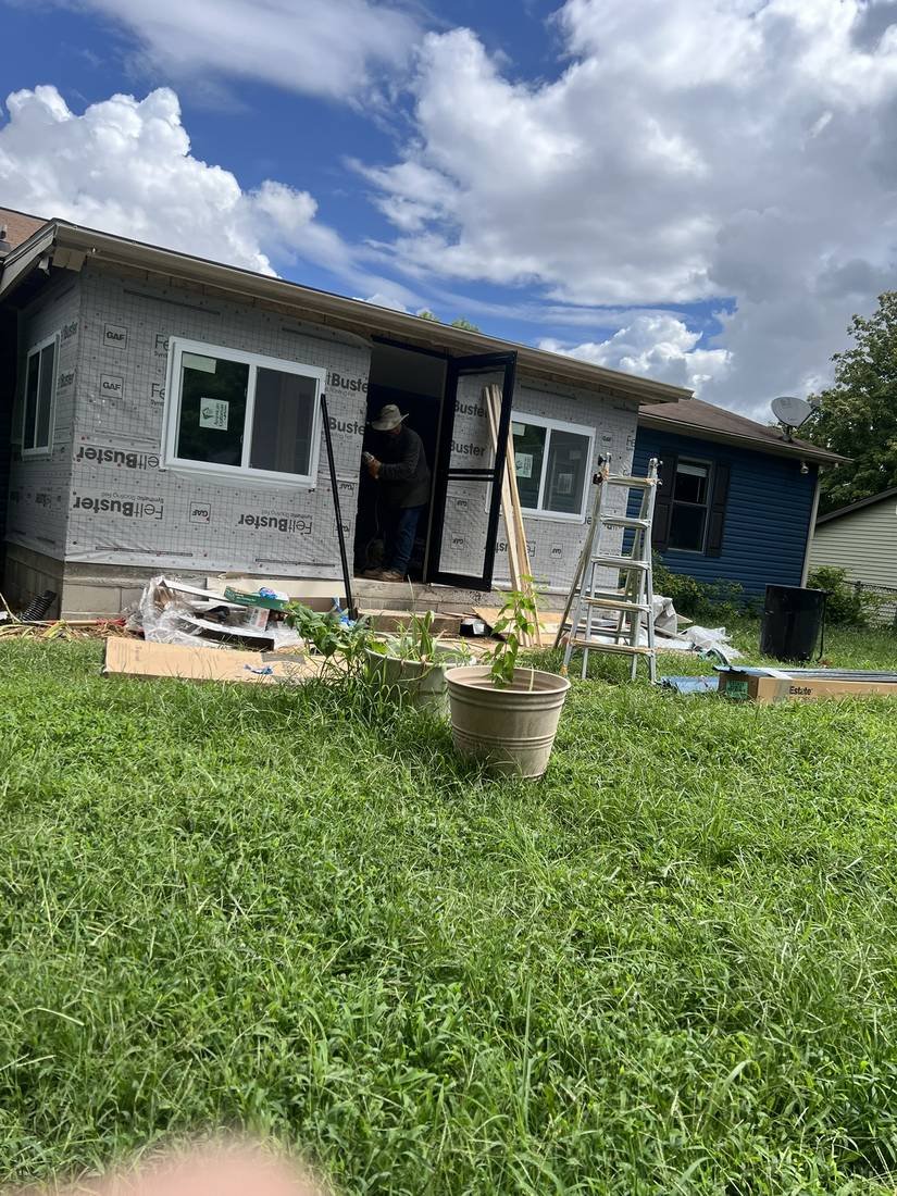 GEJ Roofing crew installing a door on the newly framed and house-wrapped porch enclosure, Murfreesboro, Tennessee