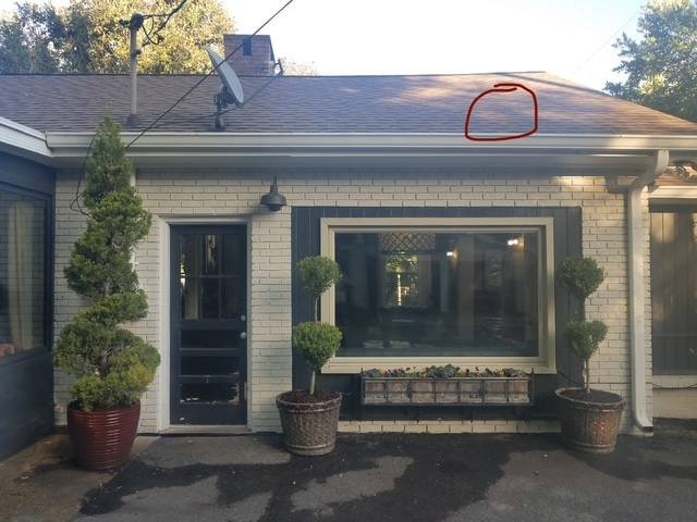 Exterior of a Nashville home with the area of a roof leak circled, found after a roof coating failed to stop it