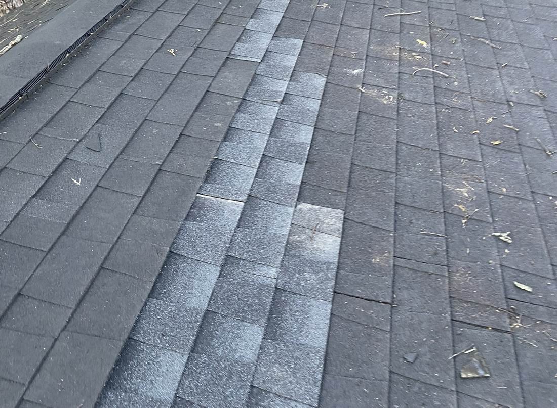 Replaced shingles forming a visible repair strip against the original roof surface, Nashville, Tennessee