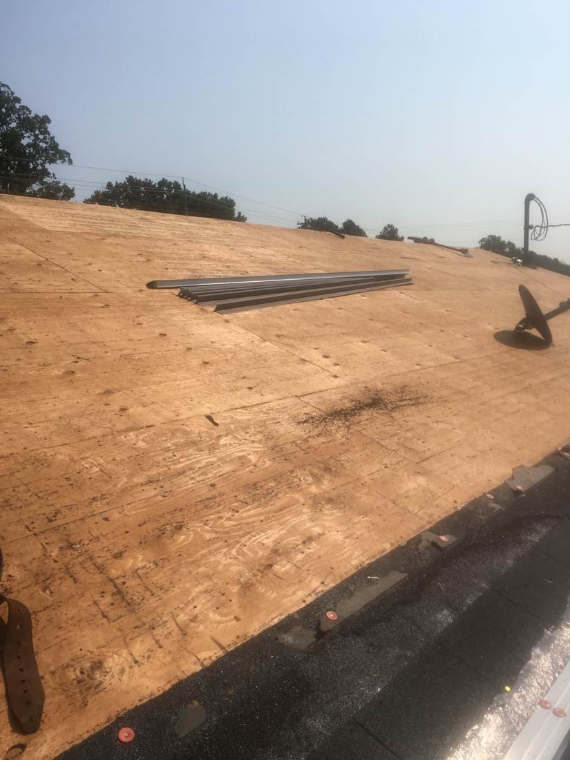 Bare roof decking exposed and ready for underlayment during a roof replacement, Tennessee