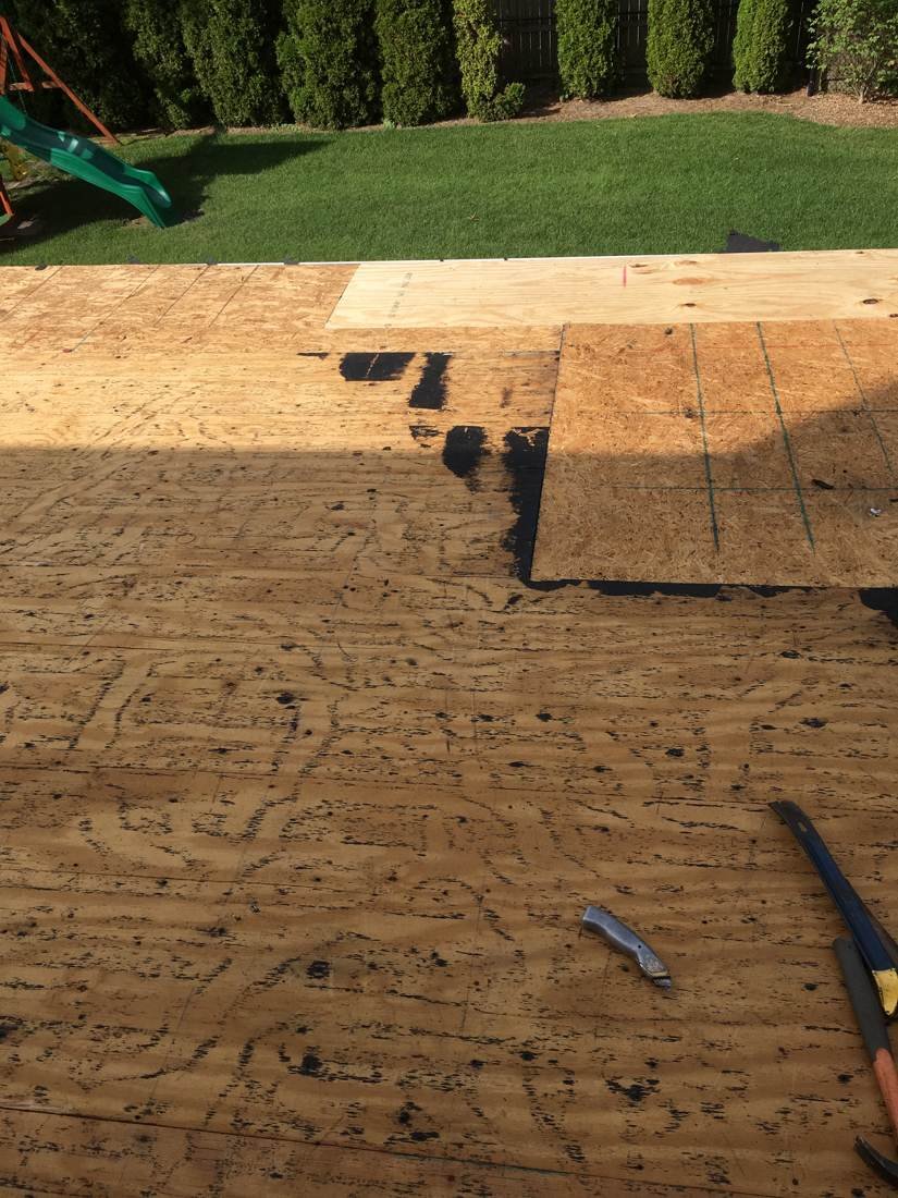 Bare roof decking on a flat, low-slope residential roof before insulation and membrane, Tennessee