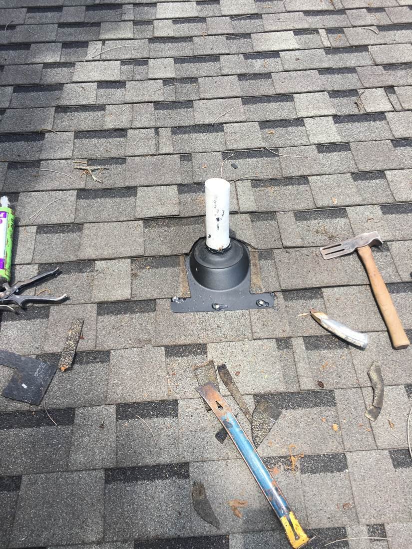 New plumbing vent pipe boot being installed on an asphalt shingle roof, Tennessee