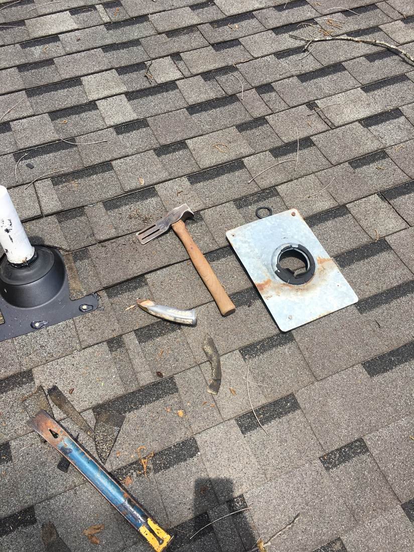 Old plumbing vent pipe boot removed from an asphalt shingle roof, Tennessee