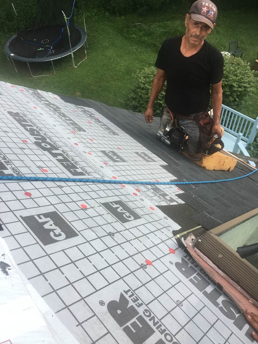 GEJ Roofing crew installing synthetic underlayment on a roof during a replacement, Tennessee