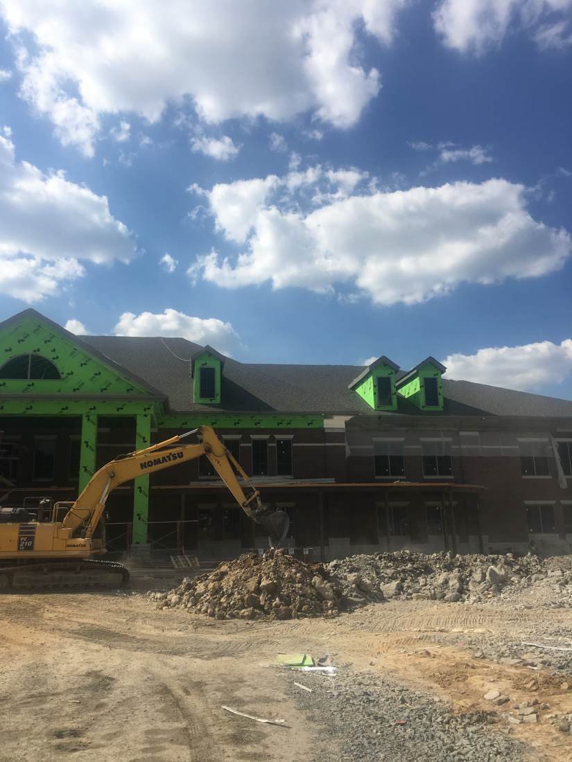 Creekside Elementary School under construction in Franklin, Tennessee, with excavator grading the site