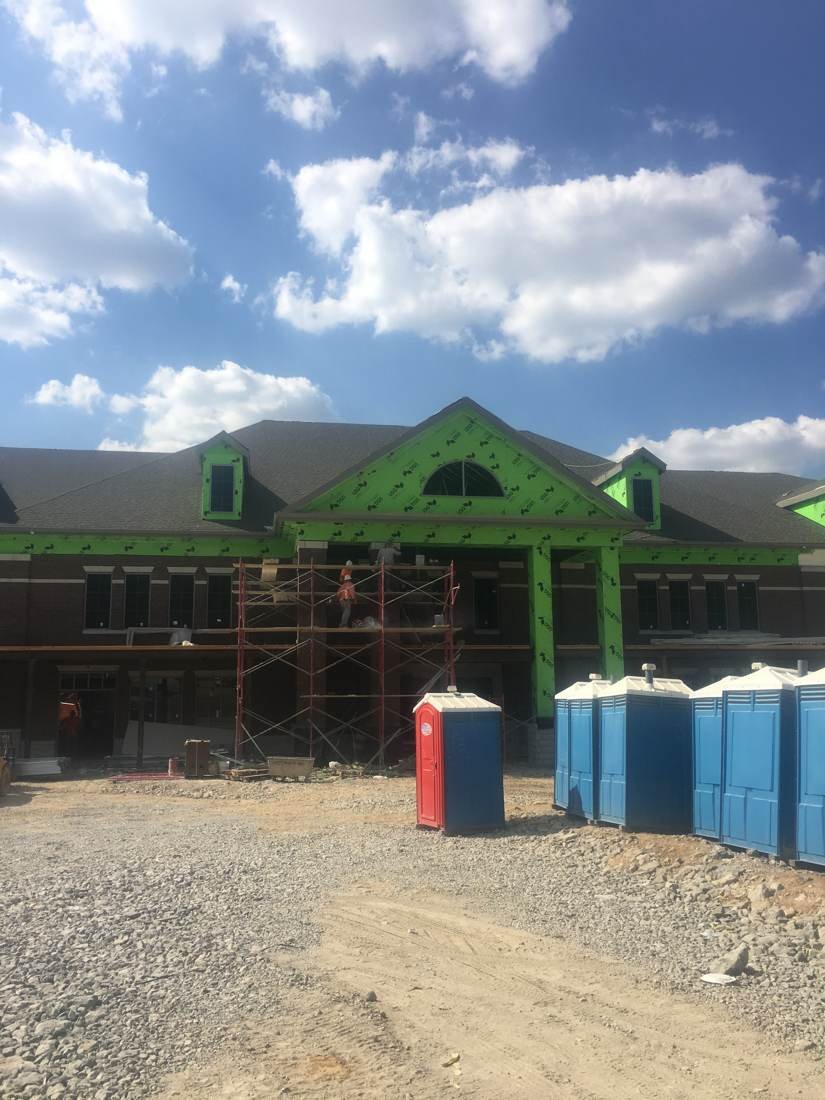 Creekside Elementary School exterior under construction in Franklin, Tennessee, with scaffolding at the entrance