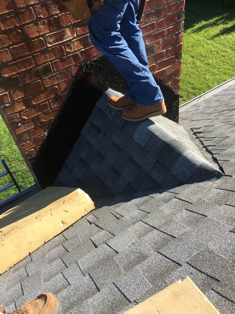 Close-up of the finished chimney cricket peak and shingle tie-in, Murfreesboro TN