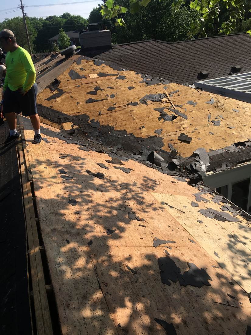 Crew tearing off the old roof during a full roof replacement in Murfreesboro, Tennessee