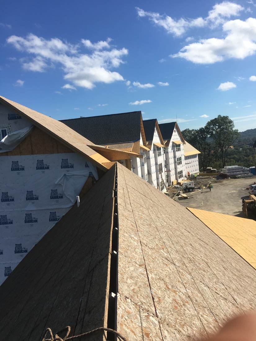 Aerial-style view from a finished roof looking across a new-construction apartment complex near downtown Nashville, Tennessee