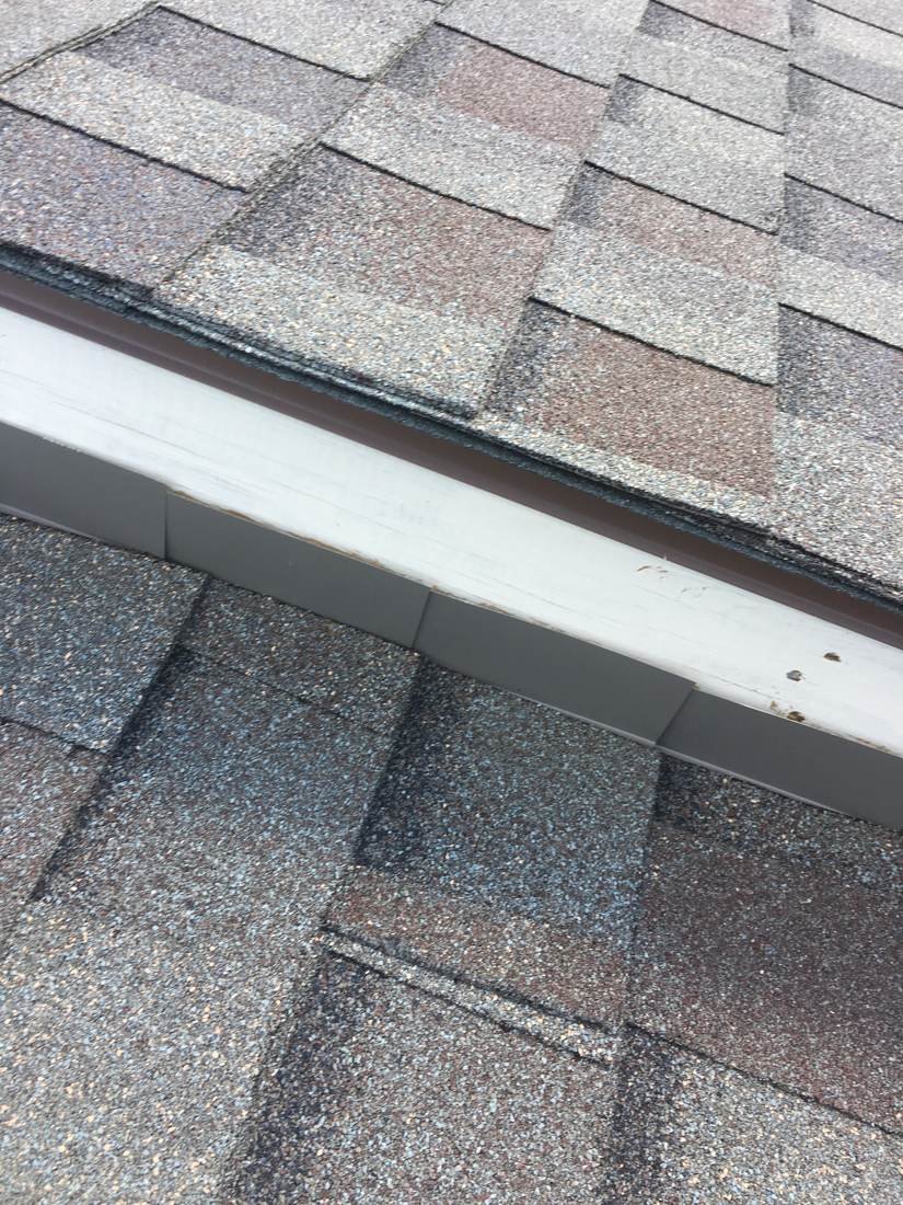 Lifted and separating drip edge flashing found during a roof inspection