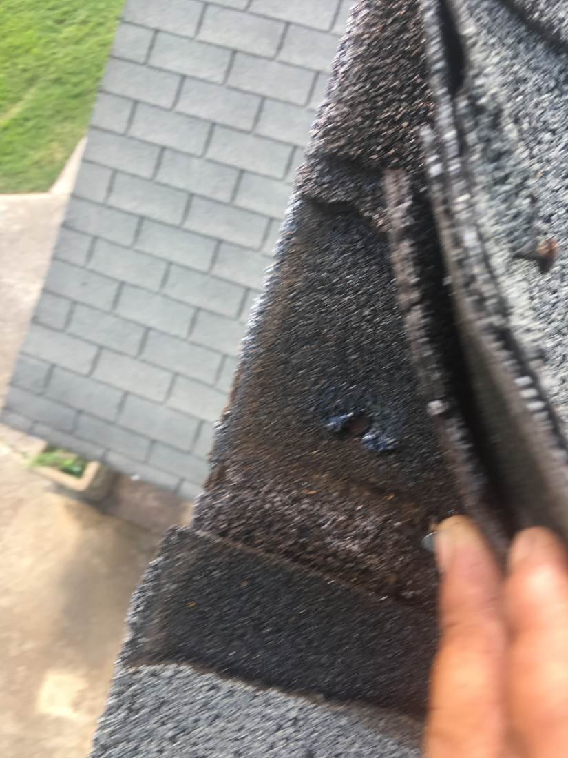 Roof valley shingle lifted to inspect for damage during a GEJ Roofing inspection