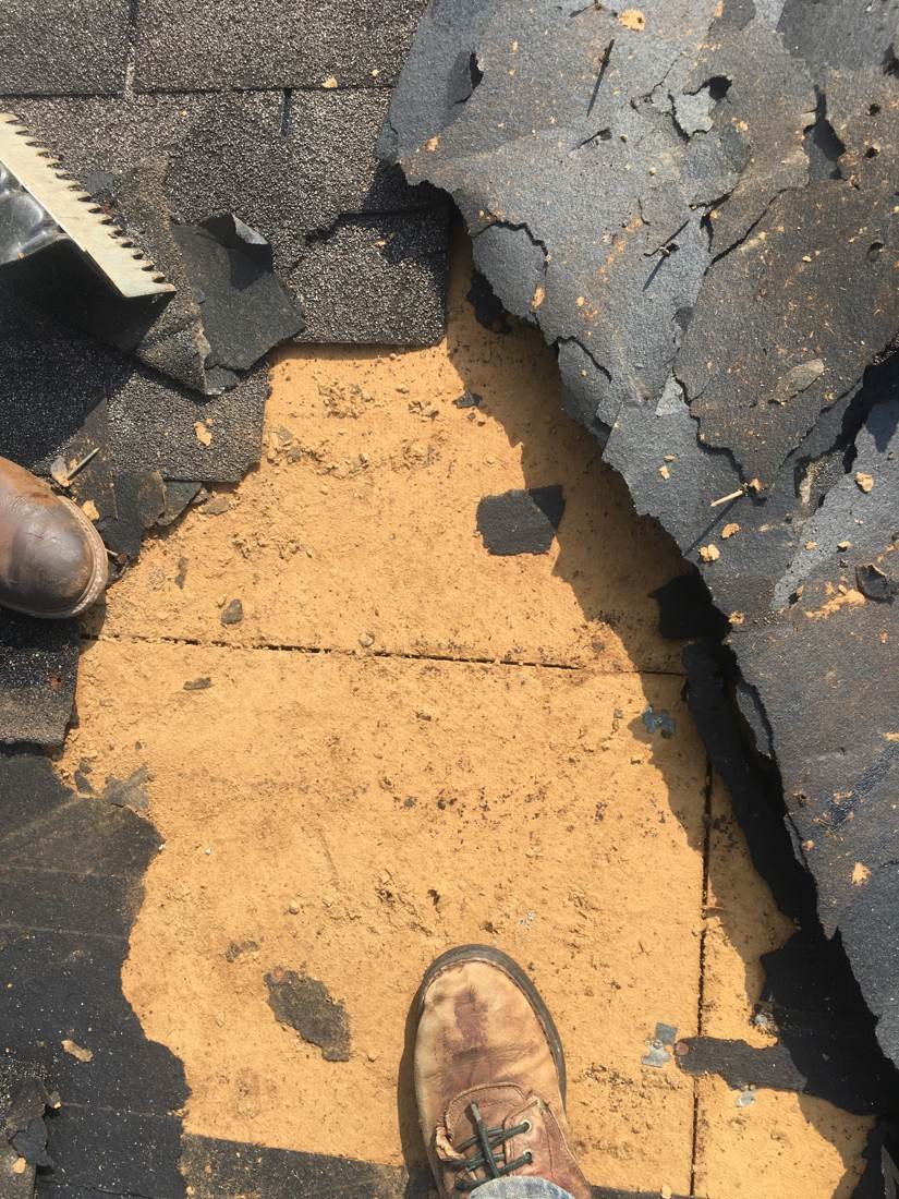 Close-up of torn shingle roofing before repair at Shelbyville Recreation Center, Tennessee