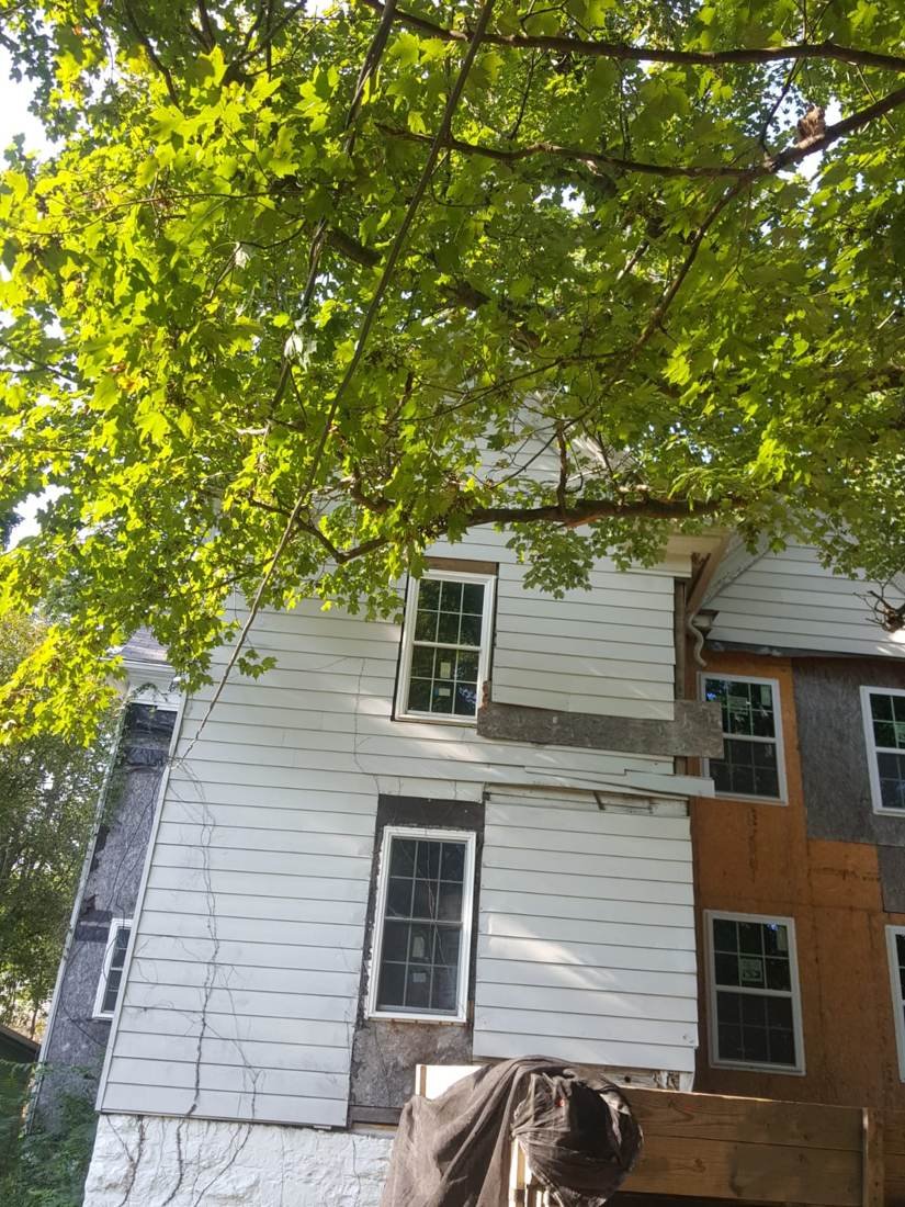 New plywood patch installed during a full siding replacement on a Tennessee farmhouse